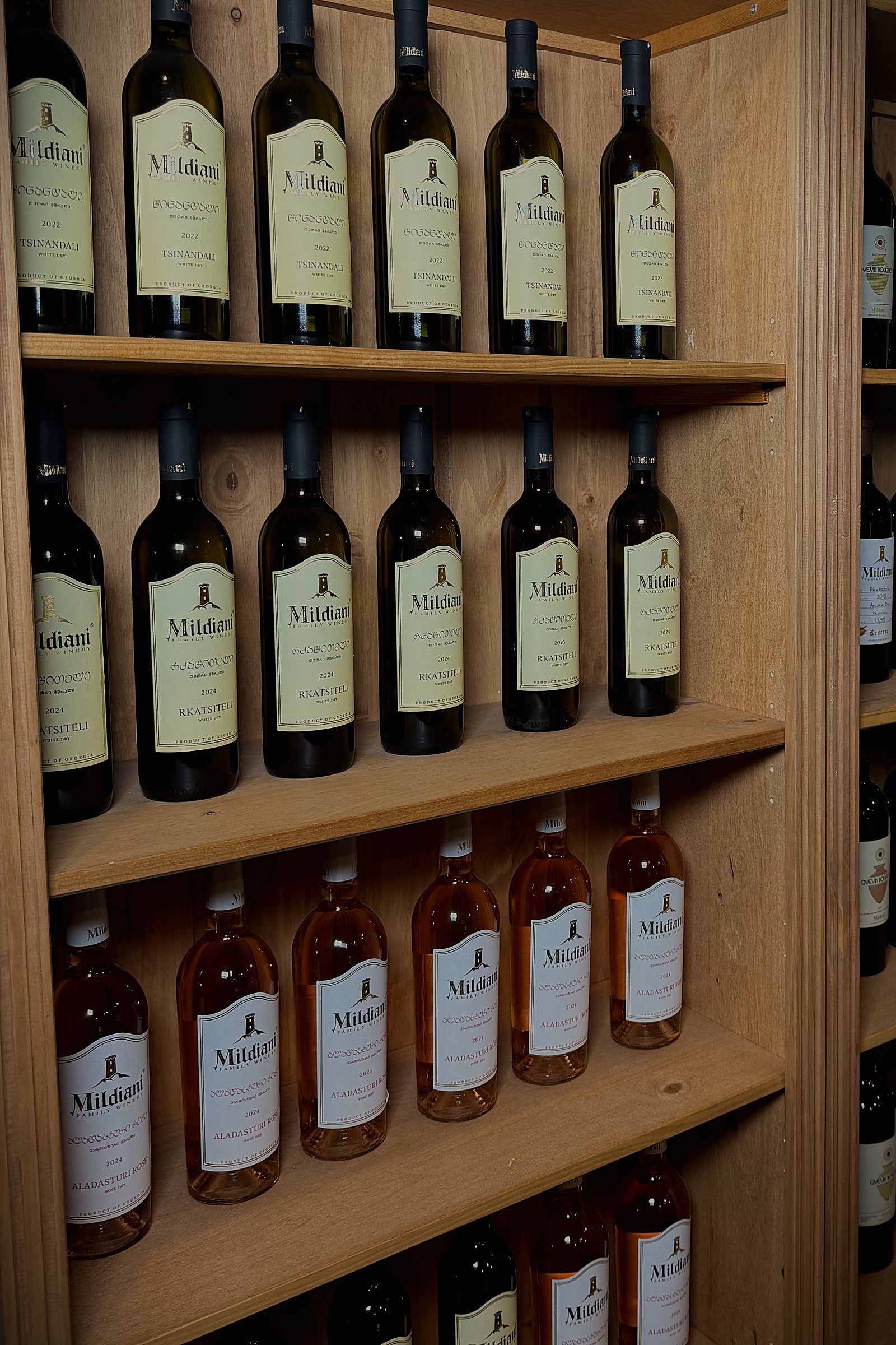 Shelves of Mildiani whites and rosé along the wall of the wine house